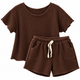 Girls' chocolate brown waffle knit two-piece outfit featuring a short-sleeve top and matching elastic-waist shorts with front pockets and light-colored drawstring.