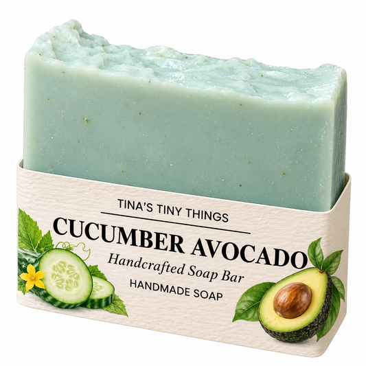 Tina's Tiny Things Cucumber Avocado Handmade Soap Bar featuring a soft mint-green body, gently textured artisan top, and cream-colored packaging decorated with fresh cucumber slices, avocado, and botanical illustrations.