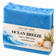 Tina's Tiny Things Ocean Breeze Handmade Goat's Milk Soap Bar featuring vibrant ocean-blue coloring, a textured wave-inspired top, and decorative coastal packaging with ocean waves, seashells, and starfish.